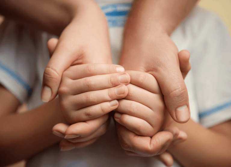Kid holding parents hands